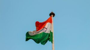 Indian national flag waving proudly against a clear blue sky in Jaipur, symbolizing patriotism and unity.